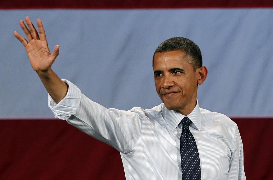 President Obama waves May 10, 2012, as he leaves the stage after speaking at a fundraising event in Seattle. (Associated Press)
