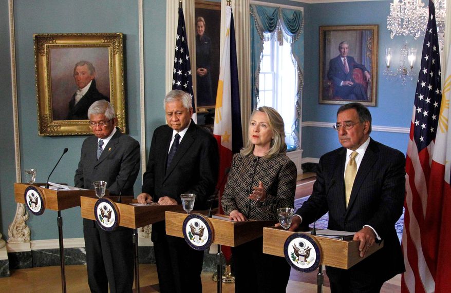 Secretary of State Hillary Rodham Clinton, Secretary of Defense Leon E. Panetta (right), Philippines' Secretary of National Defense Voltaire Gazmin (left) and Secretary of Foreign Affairs Albert del Rosario speak at a news conference at the Department of State in Washington in April. The U.S. increased military aid and resolved to help its ally on maritime security. The Philippines is locked in a standoff with China. (Associated Press)