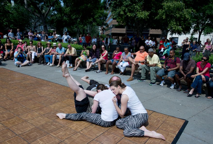 Members of modern dance company Dancethos, including Jenny Flemingloss, right, perform "Dog Days," a dance about the life of a dog, during Dance in the Circle. The event was organized by Circle Productions, who also organized a snowball fight in the circle and World Cup in the circle, both in 2010. (Barbara L. Salisbury/The Washington Times)