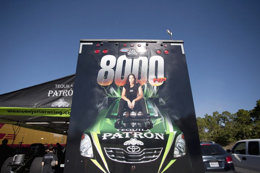 Alexis DeJoria's photo decorates the back of her haul trailer at a racetrack in Jupiter, Fla. (AP Photo/J Pat Carter)