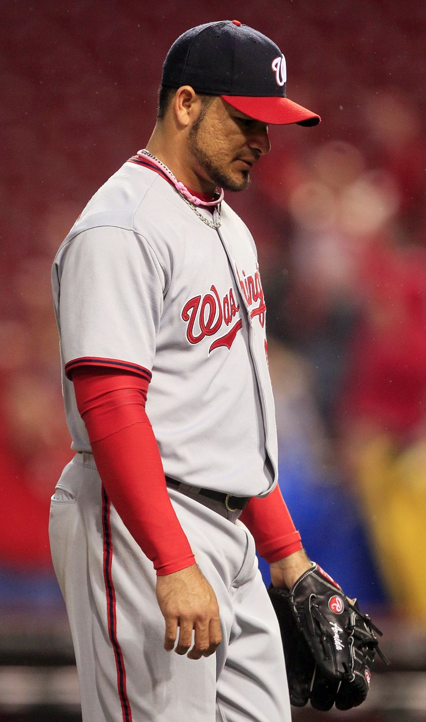 Washington Nationals relief pitcher Henry Rodriguez walks off the field after giving up a walk-off grand slam to Cincinnati Reds' Joey Votto in the ninth inning, Sunday, May 13, 2012, in Cincinnati. Cincinnati won 9-6. (AP Photo/Al Behrman)