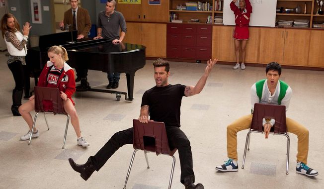 Ricky Martin (center) guest-stars on &quot;Glee&quot; in February with cast members Heather Morris (seated left) and Harry Shum Jr. (seated right). Fox is making a number of changes after the show&#x27;s viewership dropped 21 percent this season. (Associated Press)