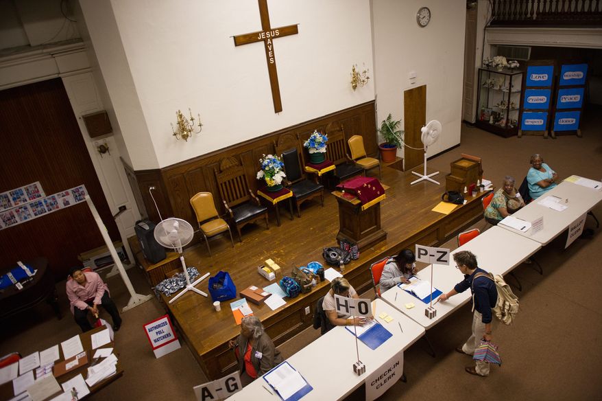 Anna Taylor (above, right) signs in at the Mount Bethel Baptist Church voting station in Northwest to cast her vote in a special election Tuesday to replace imprisoned Harry Thomas Jr. as the D.C. Council member from Ward 5. Kenyan McDuffie (left), a candidate to replace Thomas, arrives at the church in the rain to cast his vote. His wife, Princess, and two daughters accompany him. (Andrew Harnik/The Washington Times)