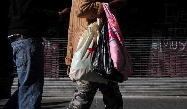 Shoppers carry their purchases along 33rd Street in New York on Sunday, May 6, 2012. (AP Photo/CX Matiash)