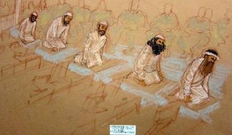 A sketch by a courtroom artist depicts the five 9/11 co-defendants praying during their arraignment at the U.S. Naval Base Guantanamo Bay, Cuba, on May 5. Their disruptive tactics stretched out the proceedings to 13 hours. (Associated Press)