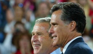 **FILE** President George W. Bush is introduced Aug. 30, 2004, by Massachusetts Gov. Mitt Romney at a campaign rally in Nashua, N.H. (Associated Press)