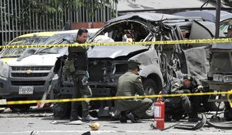 Police inspect the scene after a bomb exploded in Bogota, Colombia, Tuesday, May 15, 2012. (AP Photo/Carlos Julio Martinez)