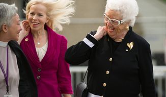 Patty Colson, center, and Emily Colson, left, the wife and daughter of Charles W. “Chuck” Colson, respectively, arrive for a memorial service honoring Colson at the Washington National Cathedral, Washington, D.C., Wednesday, May 16, 2012. Colson, who served as Special Counsel to President Richard Nixon from 1969 to 1973, turned to religion later in life around the same time he served seven months in jail for Watergate-related charges. (Andrew Harnik/The Washington Times)