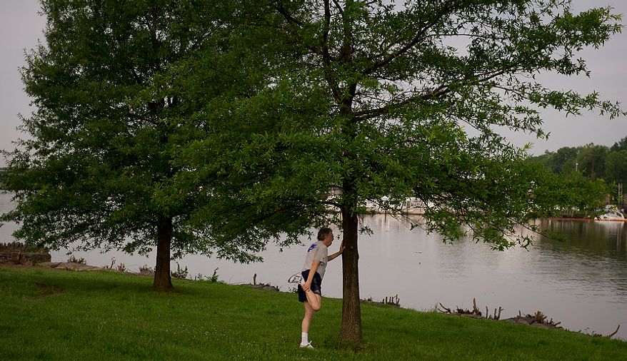 Judge John Ferren, with the team "Let Just-Us Win" stretches before running in the ACLI Capital Challenge at Anacostia Park in Washington, D.C., Wednesday, May 16, 2012. This is the 31st running of the three-mile race where members of Congress, national media outlets and locals take part in this fundraising event in the early morning hours along the water of the Anacostia River. (Rod Lamkey Jr/The Washington Times)