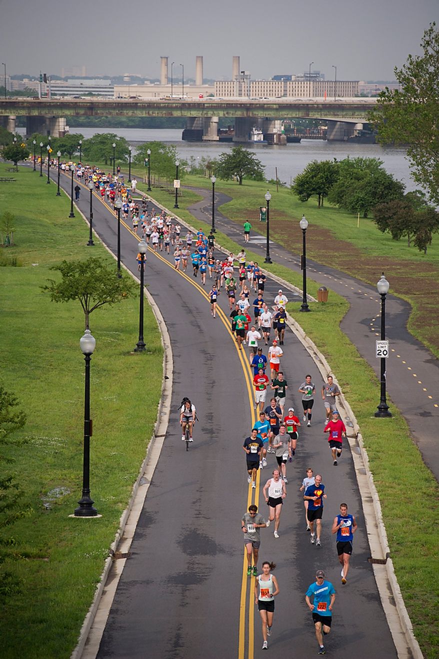 Runners make their way to the finish line during the ACLI Capital Challenge at Anacostia Park in Washington, D.C., Wednesday, May 16, 2012. This is the 31st running of the three-mile race where members of Congress, national media outlets and locals take part in this fundraising event in the early morning hours along the water of the Anacostia River. (Rod Lamkey Jr/The Washington Times)