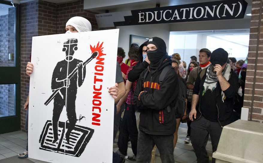 Protesters make their way through the hall of a Montreal university to disrupt classes Wednesday, May 16, 2012, in Montreal. (AP Photo/The Canadian Press, Paul Chiasson)