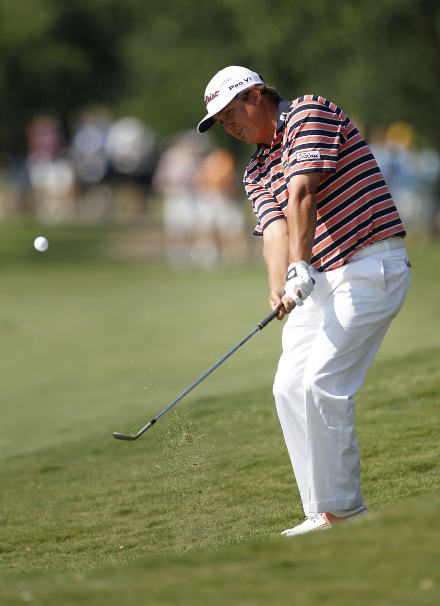 Jason Dufner chips onto the 16th green during the second round of the PGA Byron Nelson Championship on Friday, May 18, 2012, in Irving, Texas. Dufner finished with a two-round score of 7-under-par (AP Photo/Tony Gutierrez)