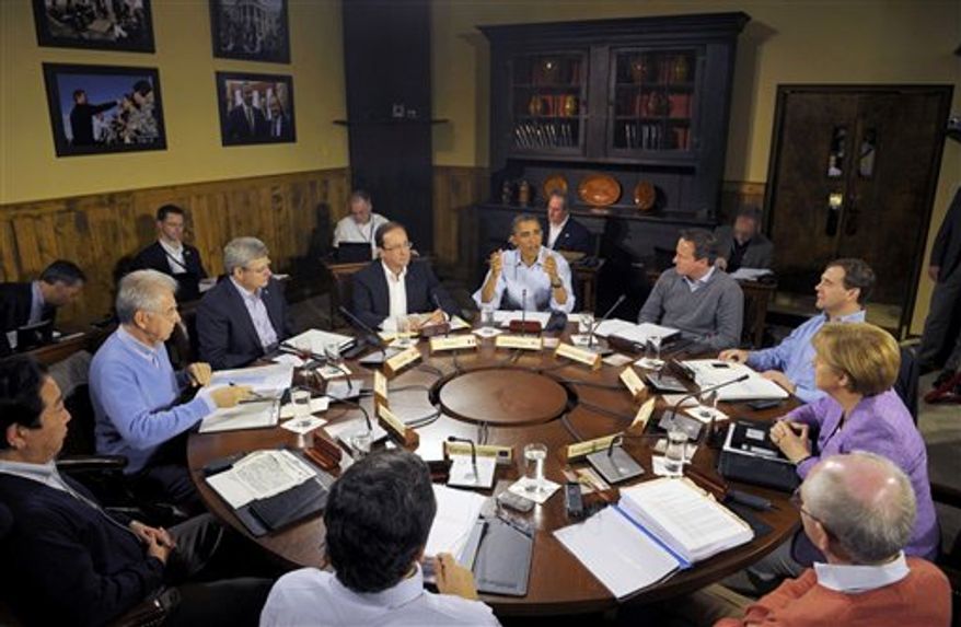 U.S. President Barack Obama, center, speaks at the start of the first working session of the G8 Summit at Camp David, Md., Saturday May 19, 2012. Seated, clockwise from left, are Japanese Prime Minister Yoshihiko Noda, Italian Prime Minister Mario Monti, Canadian Prime Minister Stephen Harper, French President Francois Hollande, Obama, British Prime Minister David Cameron, Russian Prime Minister Dmitry Medvedev, German Chancellor Angela Merkel, European Council President Herman Van Rompuy, and European Commission President Jose' Manuel Barroso, backs to camera. (AP Photo/Philippe Wojazer, Pool)