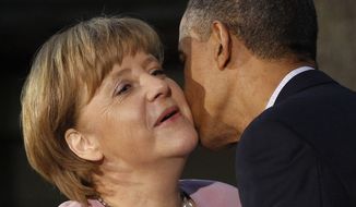 ** FILE ** President Obama kisses German Chancellor Angela Merkel on the cheek on her arrival for the G-8 summit on Friday, May 18, 2012, at Camp David, Md. (AP Photo/Charles Dharapak)
