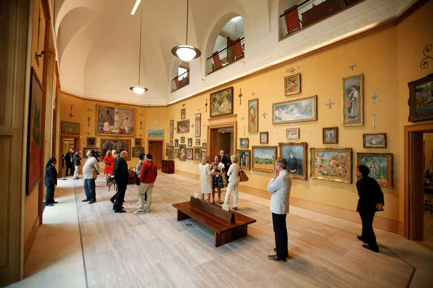 Visitors take in the main gallery during a preview of the Barnes Foundation collection last week. The collection of paintings, furniture and metalwork that underscored Dr. Albert C. Barnes' eccentric philosophy of art appreciation was moved from a relatively small suburban location to a new gallery in downtown Philadelphia. (Associated Press)