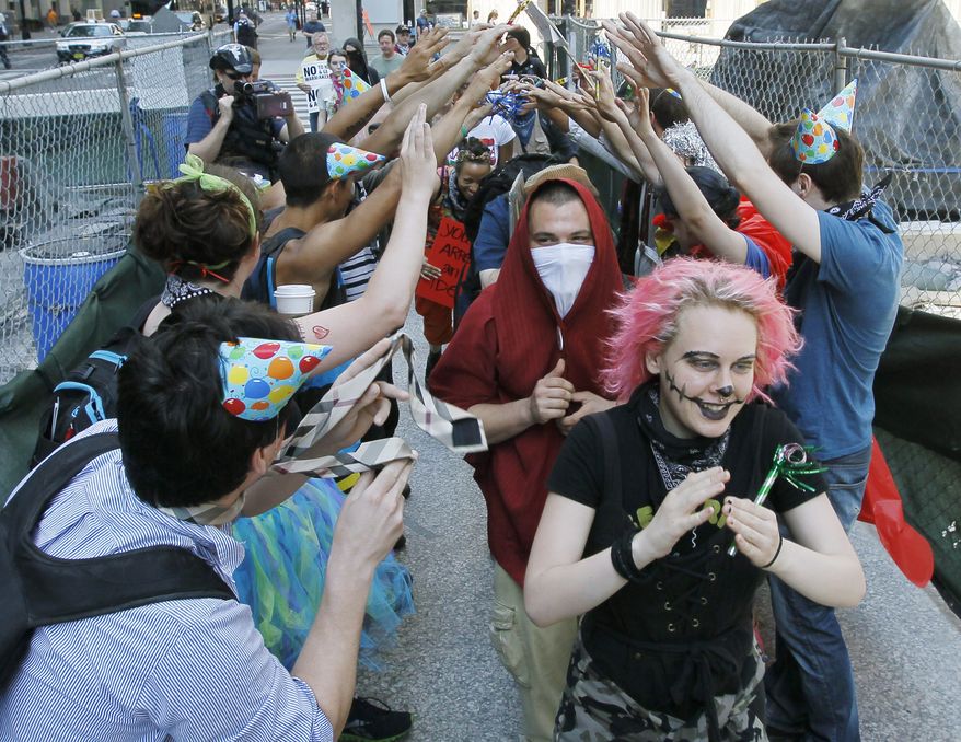 Demonstrators make their way through downtown Chicago to protest the NATO summit on Sunday, May 20, 2012. (AP Photo/Charles Rex Arbogast)