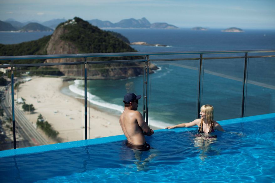 Tourists cool off at a hotel in Rio de Janeiro. The host city for the U.N.-sponsored Rio+20 conference is woefully lacking in accommodations for the green summit, with a total of 33,000 beds. Before cancellations, more than 50,000 diplomats and staffers were expected to come to Brazil for the June 20-22 summit. (Associated Press)