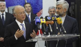 International Atomic Energy Agency (IAEA) chief Yukiya Amano (left) talks with reporters during a news briefing at the conclusion of his meeting with Iran&#39;s top nuclear negotiator, Saeed Jalili (right), in Tehran on Monday, May 21, 2012. (AP Photo/IRNA, Adel Pazzyar)

