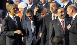 From left, President Barack Obama, NATO Secretary General Anders Fogh Rasmussen, Afghan President Hamid Karzai, Azerbaijani President Ilham Aliyev and Pakistani President Asif Ali Zardari talk during a family picture of NATO leaders at the NATO Summit in Chicago, Monday, May 21, 2012. (AP Photo/Philippe Wojazer, Pool)