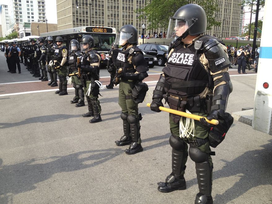 Illinois State Police stand guard May 20, 2012, on Michigan Avenue in Chicago during a protest march at the weekend's NATO summit. Security has been high throughout the city in preparation for the NATO summit, where delegations from about 60 countries will discuss the war in Afghanistan and European missile defense. (Associated Press)