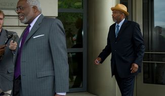 Following his attorney Frederick D. Cooke, Jr., (left) Thomas Gore, a campaign treasurer for Mayor Vincent C. Gray, makes his exit from the E. Barrett Prettyman Federal Courthouse after his plea hearing in the District on Tuesday, May 22, 2012. (Rod Lamkey Jr/The Washington Times)