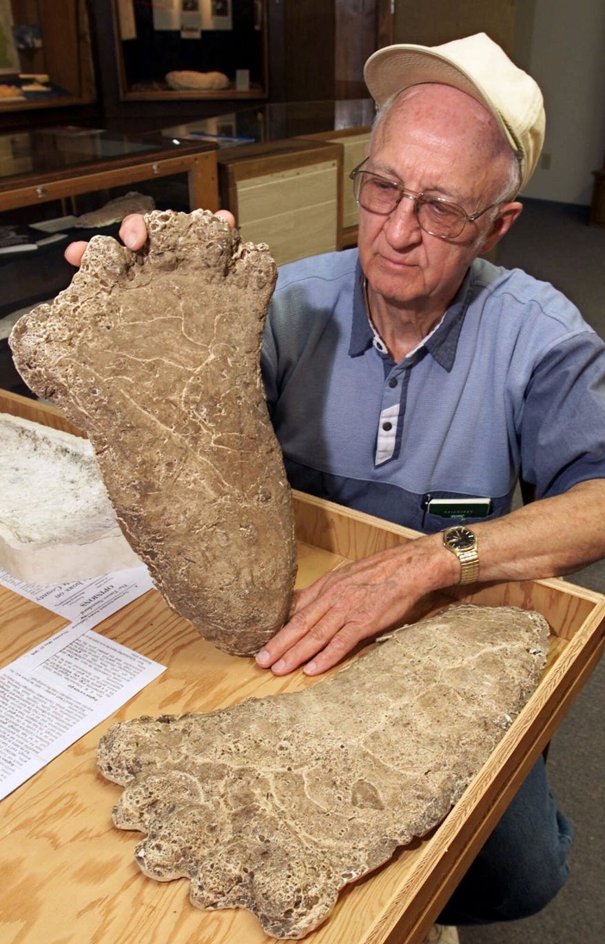 **FILE** Al Hodgson, a volunteer guide at the Willow Creek-China Flat Musuem, holds up a plaster cast of a Bigfoot imprint displayed at the museum's new "Bigfoot Wing" in Willow Creek, Calif., on June 5, 2000. (Associated Press)