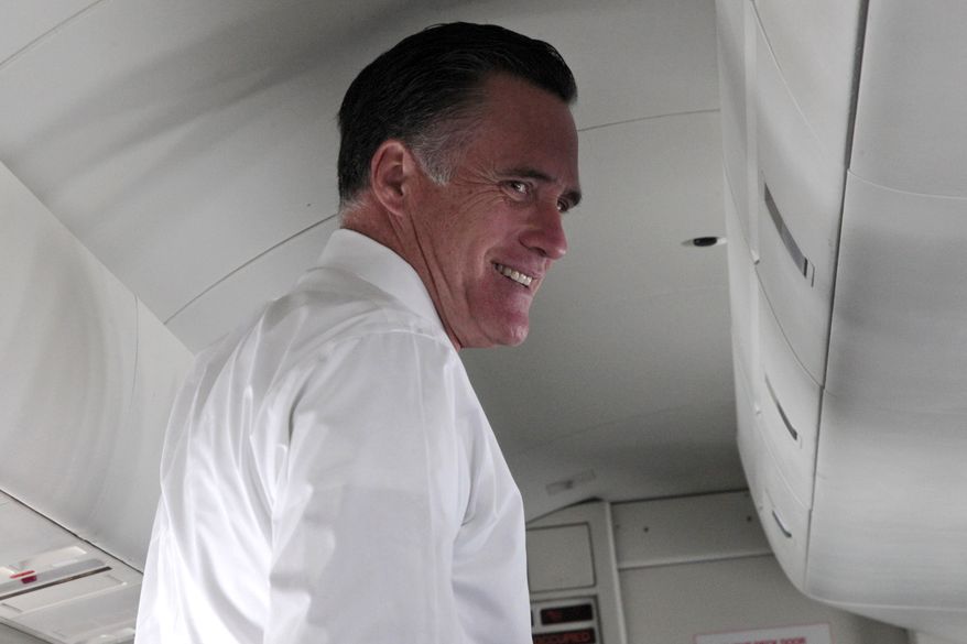Presumptive Republican presidential nominee Mitt Romney speaks to reporters on a campaign charter flight between New York and Washington on Wednesday, May 23, 2012. (AP Photo/Mary Altaffer)