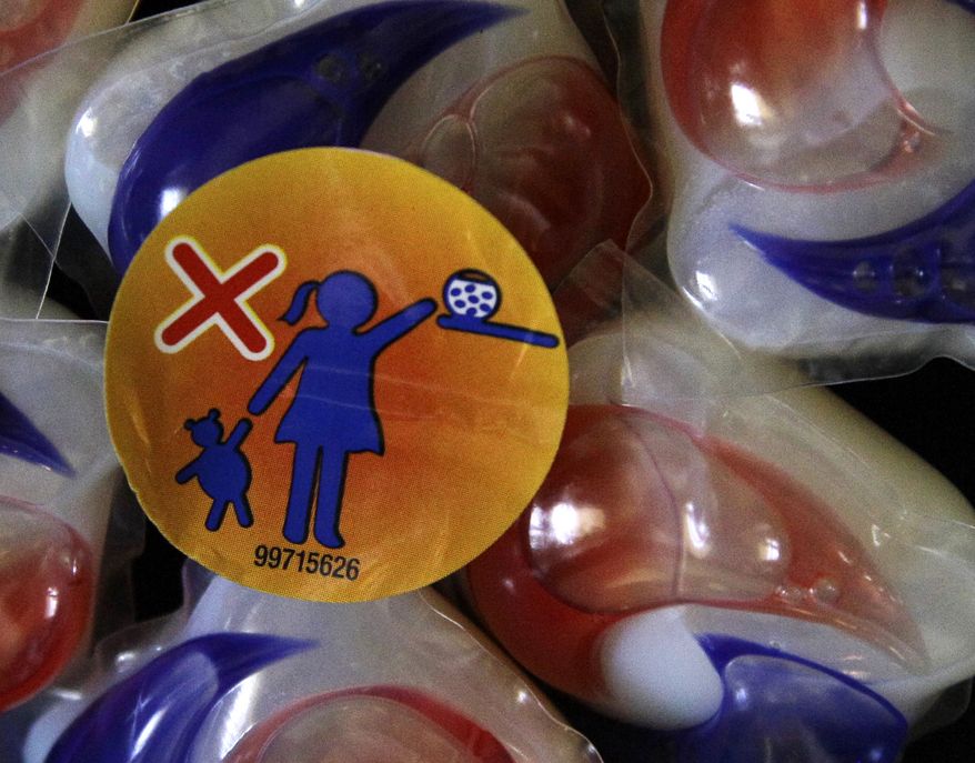 A warning label is attached to a package of Tide laundry detergent packets in Houston on May 24, 2012. The miniature detergent packets arrived on store shelves in recent months, touted as a solution to bulky bottles and messy spills. But doctors across the country say children are confusing the tiny, brightly colored packets with candy and swallowing them. Nearly 250 cases have been reported to poison control centers. (Associated Press)