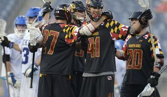 Maryland&#39;s Kevin Cooper (41) celebrates a fourth-quarter goal with teammates, from left, Kevin Forster, Owen Blye and Billy Gribbin (20) during an lacrosse semifinal match against Duke at Gillette Stadium in Foxborough, Mass., on Saturday, May 26, 2012. (AP Photo/Gretchen Ertl)