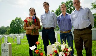 Robin Penaherrera (second from left), founder of Memorial Day Flowers, and his team — Sophia Romero (left), Nick Richwine (second from right) and Dean Rule (right) — are pictured in Section 60 at Arlington National Cemetery on Friday, May 25, 2012. Mr. Penaherrera, his team and volunteers will pass out 50,000 roses and 1,000 bouquets at the cemetery on Memorial Day. (Rod Lamkey Jr./The Washington Times)