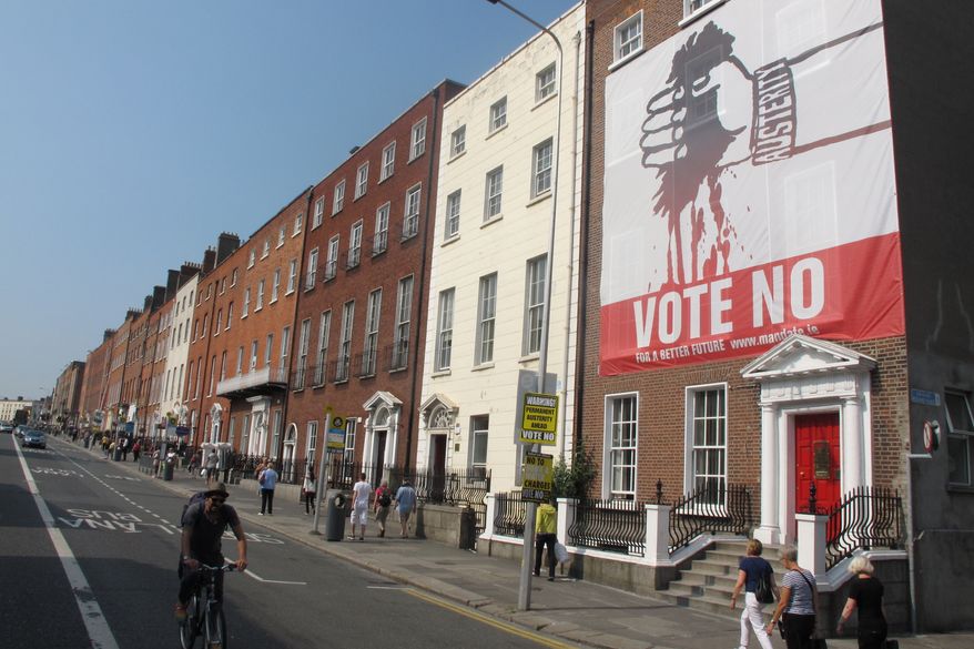 In Dublin, a huge banner depicting Ireland&#x27;s being bled dry by austerity calls for a &quot;no&quot; vote in the referendum on the European Union&#x27;s fiscal treaty. (AP Photo/Shawn Pogatchnik)