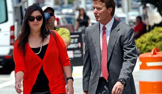** FILE ** John Edwards, a former presidential candidate, and daughter Cate Edwards return to federal court after a break during the sixth day of jury deliberations in Greensboro, N.C., on Friday. (Associated Press)