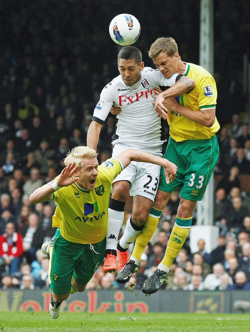 Clint Dempsey is adept at using his head (below, center) as well as his feet in making dynamic plays on the pitch. (AP Photo/Tim Hales)