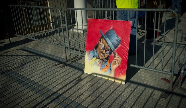 Artwork depicting the image of Chuck Brown rests up against the barricades as his body lies in repose at the Howard Theatre in Washington, D.C., Tuesday, May 29, 2012. Mr. Brown died on May 16, 2012. He was 75.(Rod Lamkey Jr/The Washington Times)