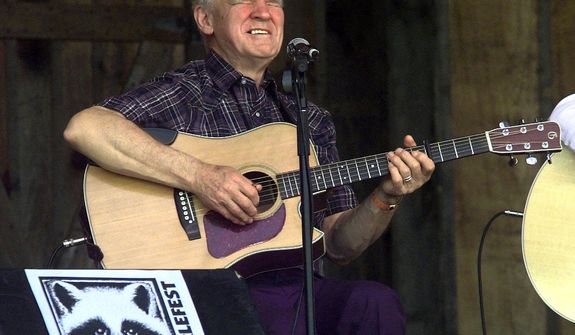 **FILE** Master flatpicker Doc Watson performs April 28, 2001, at the annual Merlefest at Wilkes Comunity College in Wilkesboro, N.C. Watson, the Grammy-award winning folk musician whose lightning-fast style of flatpicking influenced guitarists around the world for more than a half-century, died May 29, 2012, at a hospital in Winston-Salem. He was 89. (Associated Press)