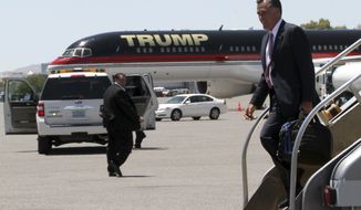 Republican presidential candidate, former Massachusetts Gov. Mitt Romney walks past Donald Trump&#39;s airplane as he arrives in Las Vegas, Tuesday, May 29, 2012. (AP Photo/Mary Altaffer)