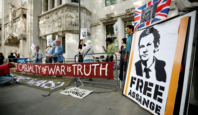 Supporters of WikiLeaks founder Julian Assange demonstrate Wednesday in London outside Britain&#x27;s Supreme Court, prior to its ruling greenlighting Mr. Assange&#x27;s extradition to Sweden. (Associated Press)