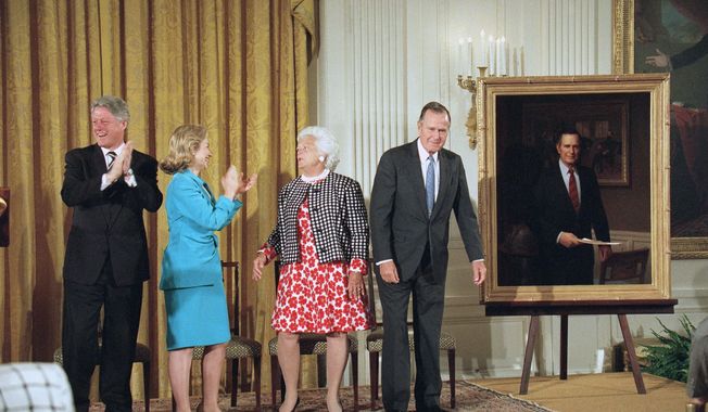 President Bill Clinton and first lady Hillary Rodham Clinton applaud as former President George H.W. Bush and former first lady Barbara Bush stand near the presidential portrait of Mr. Bush at its unveiling at the White House in 1995. A portrait of Mrs. Bush was unveiled as well. (Associated Press)