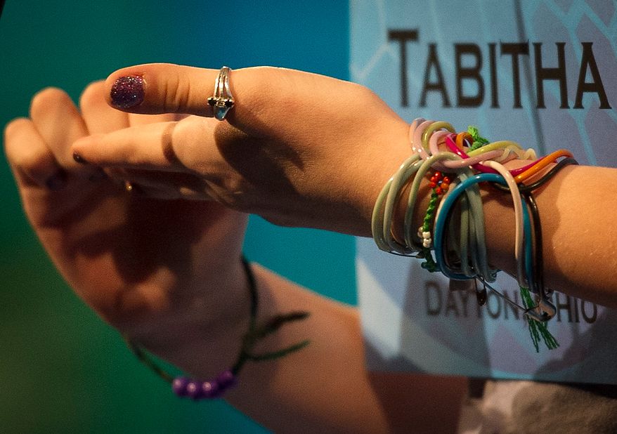 Tabitha Esme Wells, 13, of Vandalia, Ohio, uses her hands to helper her work on her word, neuroticism, which she did correctly, during the preliminary rounds of the 2012 Scripps National Spelling Bee at the Gaylord National Resort and Convention Center in National Harbor, Md., Wednesday, May 30, 2012. This year, 278 spellers from around the United States and all walks of life will compete for the title of 2012 Scripps National Spelling Bee champion. (Rod Lamkey Jr/The Washington Times)