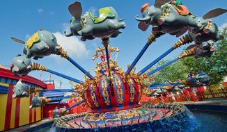 ** FILE ** Dumbo takes youngsters for a ride in Walt Disney World&#39;s Fantasyland area. (Associated Press)