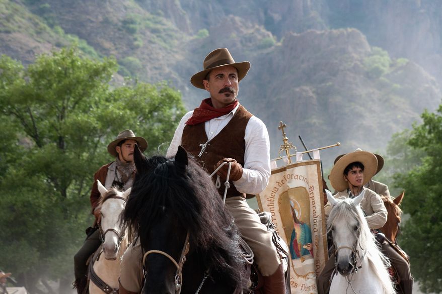 In "For Greater Glory,"Andy Garcia plays a general who sides with Catholics in the Cristero War of the 1920s over the Mexican government's restrictions on worship. With him, holding the flag, is Mauricio Kuri. The mostly Latino cast speaks in English. (ARC Entertainment via Associated Press)