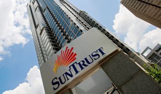 SunTrust Mortgage, a subsidiary of SunTrust Bank, has agreed to pay $21 million to resolve a suit in which the Justice Department claimed it increased interest rates and fees for qualified black and Hispanic borrowers. (Associated Press)