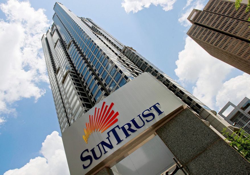 SunTrust Mortgage, a subsidiary of SunTrust Bank, has agreed to pay $21 million to resolve a suit in which the Justice Department claimed it increased interest rates and fees for qualified black and Hispanic borrowers. (Associated Press)
