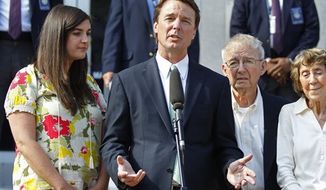 ** FILE ** John Edwards speaks May 31, 2012, outside a federal courthouse as his daughter Cate Edwards (left) and parents Wallace Edwards (second from right) and Bobbie Edwards look on after the jury&#39;s verdict in his trial on charges of campaign corruption in Greensboro, N.C. (Associated Press)