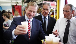 Irish Prime Minister Enda Kenny takes a glass of apple juice at the Bord Bia Bloom festival in the Phoenix Park, Dublin, on June 1, 2012. Referendum officials compiling unofficial results say Ireland&#39;s voters have decided to ratify the European Union&#39;s deficit-fighting treaty with &quot;yes&quot; votes reaching nearly 60 percent. (Associated Press)