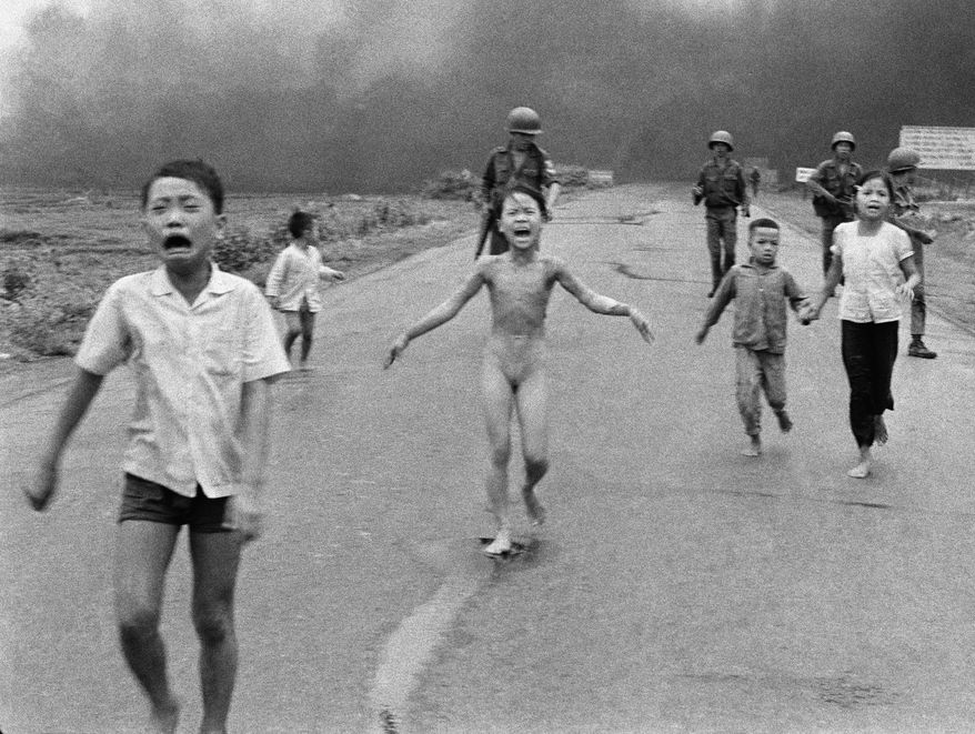 Nine-year-old Kim Phuc (center) runs down Route 1 near Trang Bang, Vietnam, on June 8, 1972, after an accidental aerial napalm attack as South Vietnamese forces from the 25th Division walk behind. With her (from left) are her younger brothers Phan Thanh Tam, who lost an eye, and Phan Thanh Phouc and her cousins Ho Van Bon and Ho Thi Ting. (AP Photo/Nick Ut)