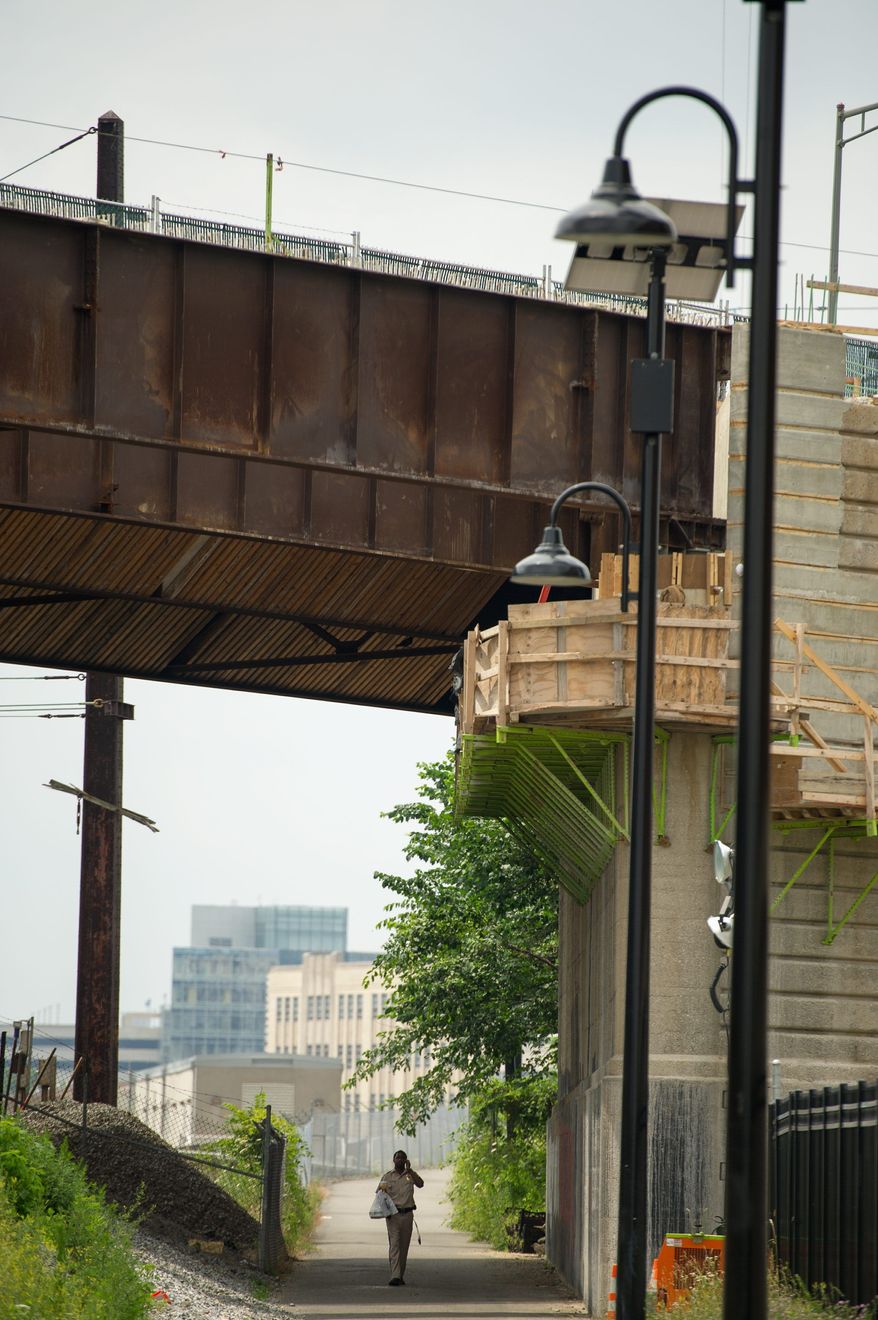Phase one of the New York Avenue Bridge project is nearing completion. Heavy train traffic under the bridge has limited the time workers are given to safely do reconstruction near the tracks. (Andrew Harnik/The Washington Times)