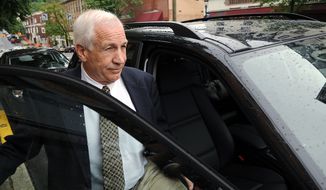 **FILE** Jerry Sandusky gets into his attorney Joe Amendola&#39;s car May 29, 2012, near the Centre County Courthouse Annex in Bellefonte, Pa., following a closed-door meeting with the judge in his child sexual abuse case. (Associated Press/Centre Daily Times)