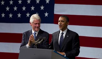 Former President Bill Clinton claps as President Obama arrives to speak at a campaign event at the New Amsterdam Theatre in New York on June 4, 2012. (Associated Press)