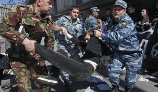 Russian police detain protesters outside the parliament building in Moscow on Tuesday, June 5, 2012, during a demonstration against a proposed law that would increase fines for participating in unsanctioned rallies. (AP Photo/Misha Japaridze)